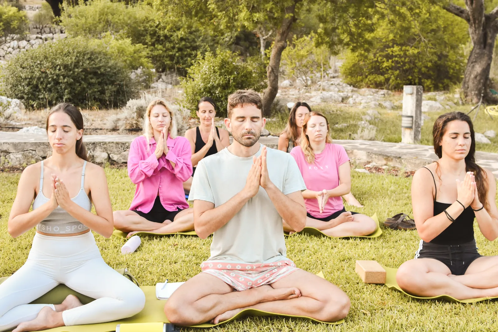Group meditation by the pool at La Serranía, Mallorca, facing the Tramuntana mountains